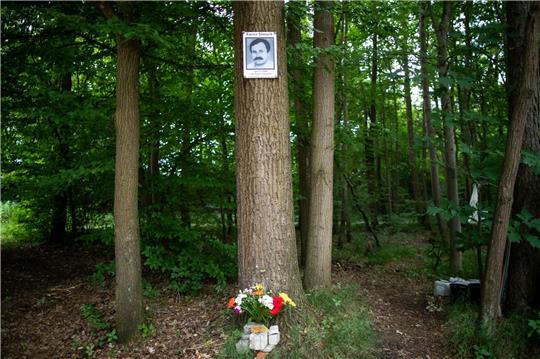 Eine Gedenktafel mit dem Abbild des NSU-Opfers Enver Simsek hängt 2018 am Tatort in Nürnberg an einem Baum.