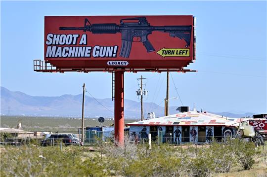 Eine Reklametafel im US-Bundesstaat Arizona wirbt für das Schießen mit einem Maschinengewehr auf einem Schießstand.