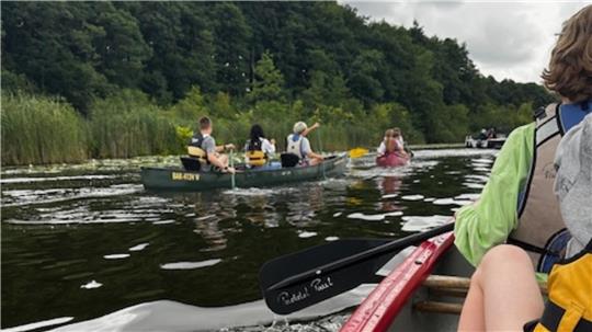 Einige Kinder steigen in der Mecklenburgischen Seenplatte zum ersten Mal in ein Kanu.