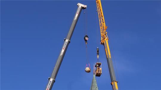 Einsatz an und über den Dächern von Goslar: Gunnar Trull und Andreas Lochmann von den Werkstätten für Denkmalpflege Quedlinburg kümmern sich in luftiger Höhe um die Marktkirchen-Spitze.
