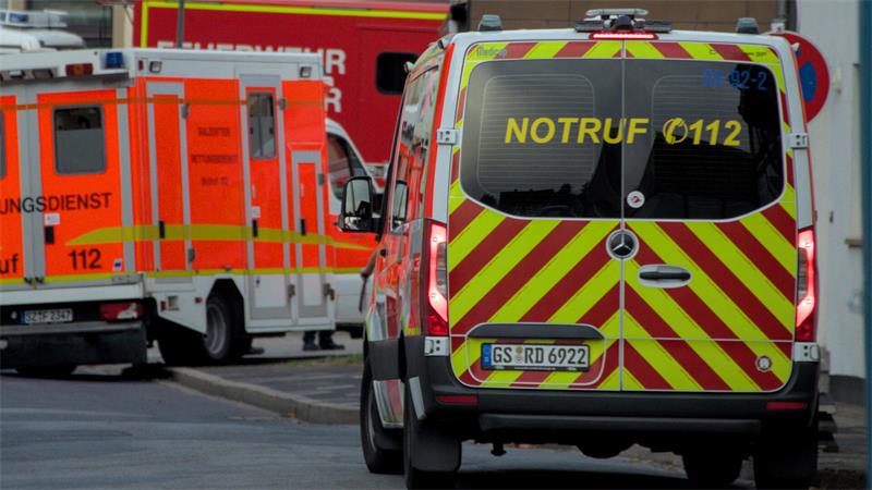 Mehrere Rettungsdienstfahrzeuge stehen im Einsatz in einer Straße. Im Vordergrund ist ein Einsatzfahrzeug mit gelb-roter Warnbeklebung und der Aufschrift ‚Notruf 112‘ zu sehen, dahinter stehen weitere Rettungsfahrzeuge.