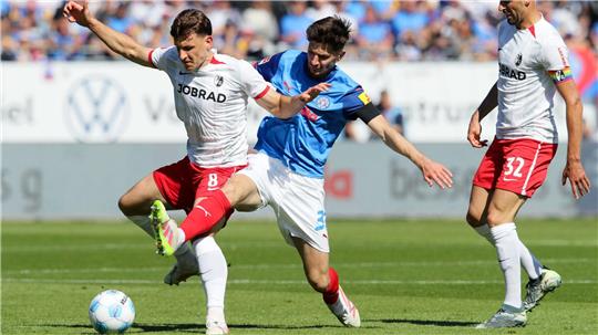 Freiburgs Maximilian Eggestein (l) und Kiels Armin Gigovic kämpfen um den Ball.