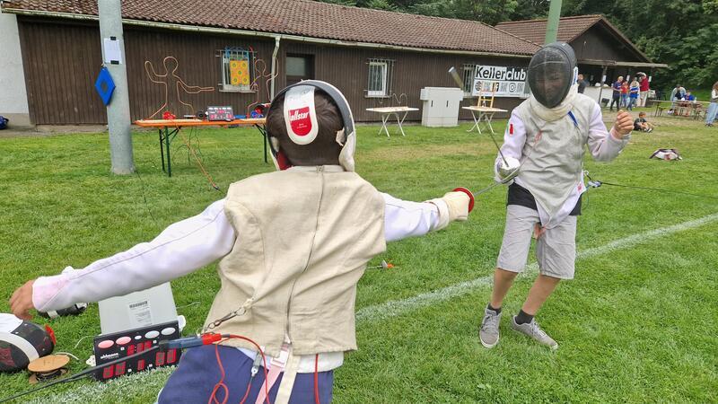 Gut geschützt und mit Kabeln ausgestattet probieren sich die Besucher im Fechten aus.