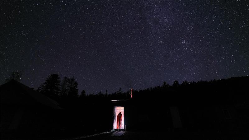 Forschung extrem: Schwarzlicht-Frösche und eisige Einsamkeit Hao-Cheng Yu geht unter einem spektakulären Sternenhimmel in die Hütte, die er während seiner Forschungen bewohnte.