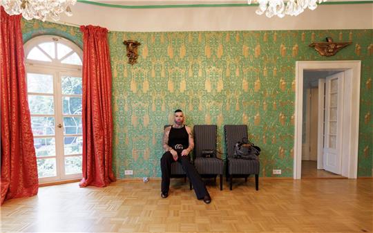Harald Glööckler sitzt in einem nahezu leeren Raum seines alten Hauses.