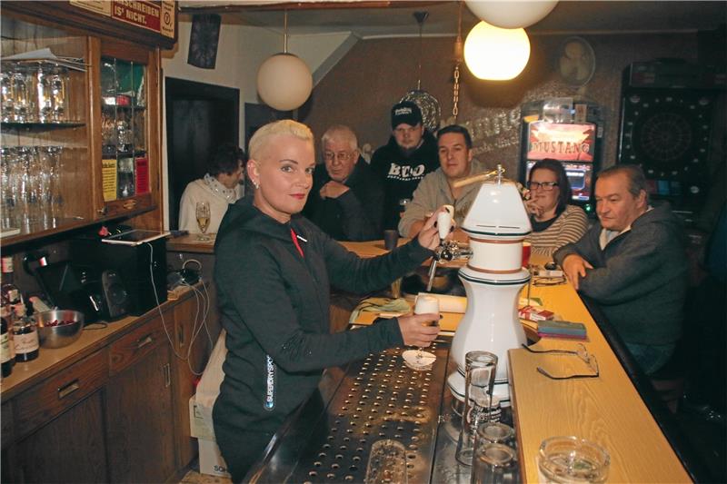 Heike Kemper zapft im Kreis einiger ihrer Stammgäste ein Bier in der „Kupferkanne“.  Fotos: Stade
