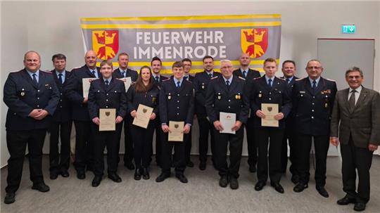 Helge Brennecke (links), die Geehrten und Beförderten der Ortsfeuerwehr Immenrode und Stadtbrandmeister Christian Hellmeier und Bürgermeister Axel Siebe (rechts).