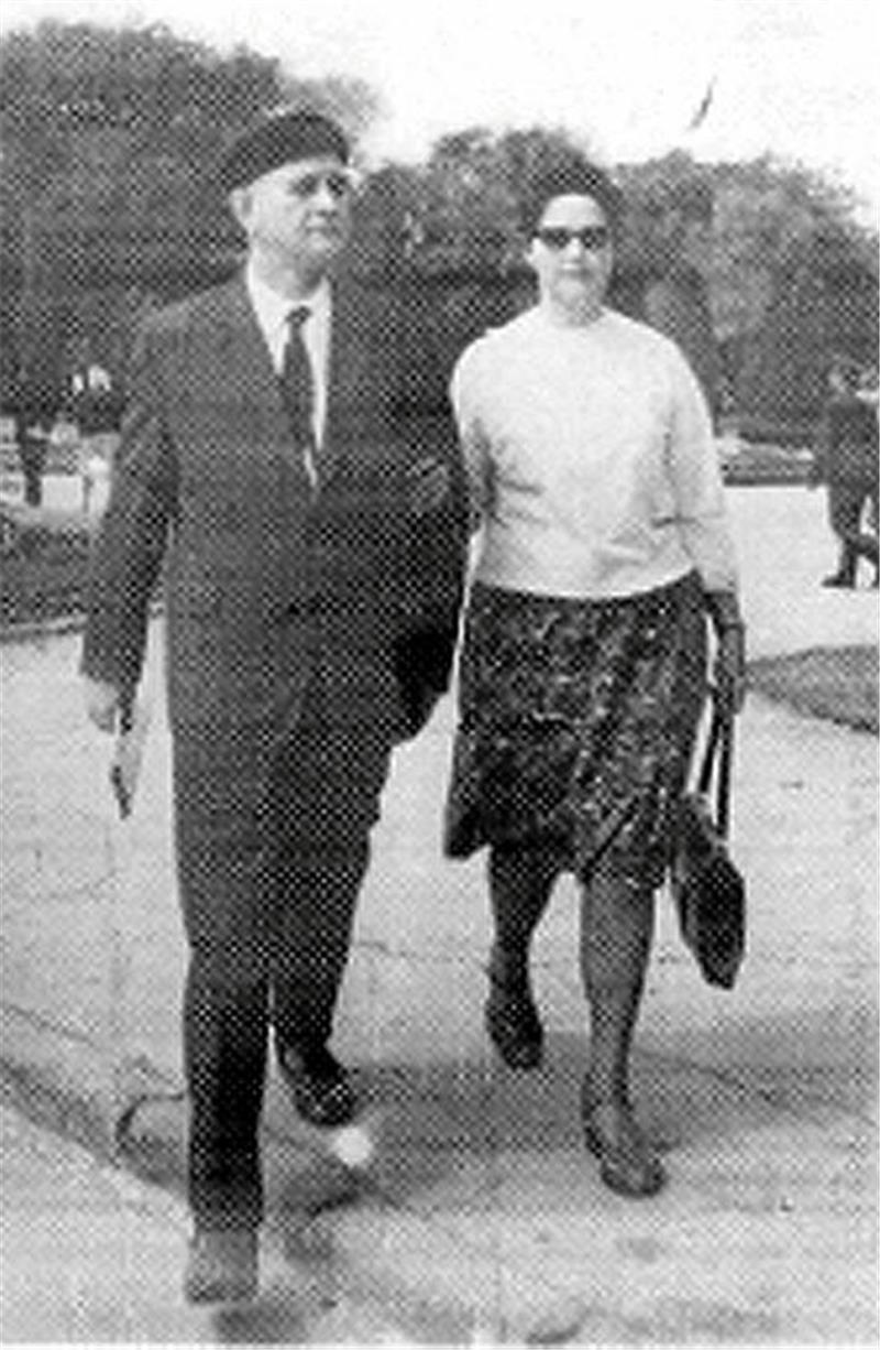 Tod in Odessa: Sohn eines Goslarer Zwangsarbeiterkindes stirbt Ein Mann im Anzug und eine Frau mit Rock und Pullover gehen nebeneinander auf einem Gehweg, im Hintergrund Bäume und weitere Personen.