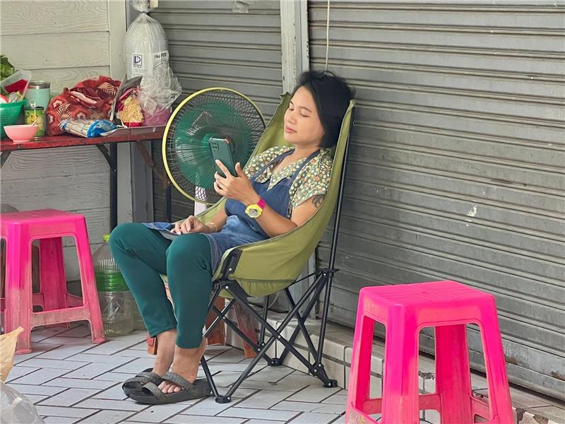 Wie im Backofen: Rekord-Hitzewelle von Thailand bis Vietnam Im Schatten und mit Ventilator: Eine Frau in Bangkok versucht, sich sich abzukühlen.