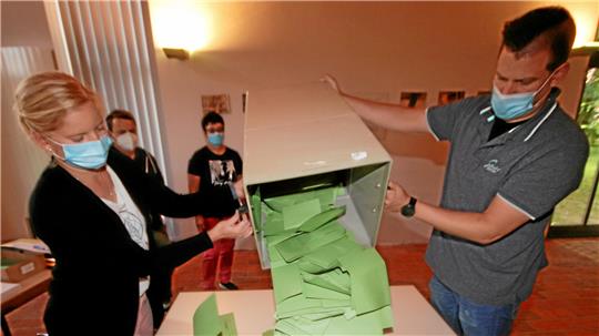 Wahlhelfer leeren eine Wahlurne aus.