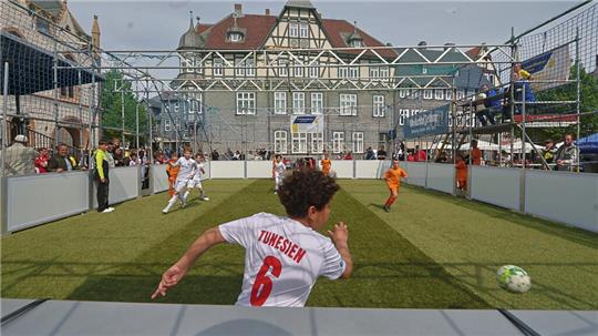 Kinder spielen Fußball auf einem kleinen Spielfeld