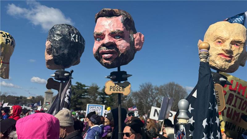 In Washington tragen Demonstrierende Pappköpfe, die unter anderem den US-Vizepräsidenten J.D. Vance (M) darstellen sollen.