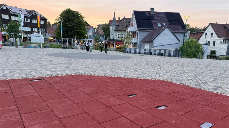 Das Foto zeigt einen Platz mit weichen Fallschutzplatten im Vordergrund.