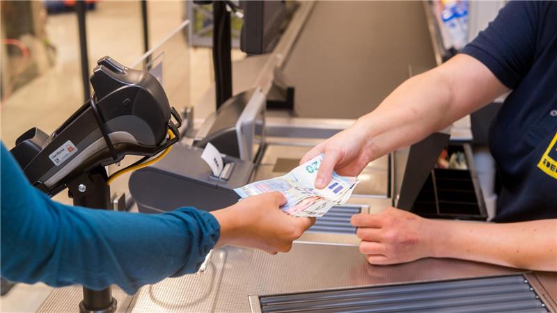 Bundesbank: Zugang zu Bargeld aufwendiger geworden In einem Supermarkt hebt eine Kundin beim Bezahlen auch gleich Bargeld ab.