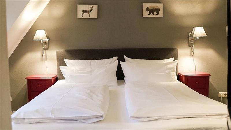 Das Foto zeigt ein Doppelbett in einem Schlafzimmer.