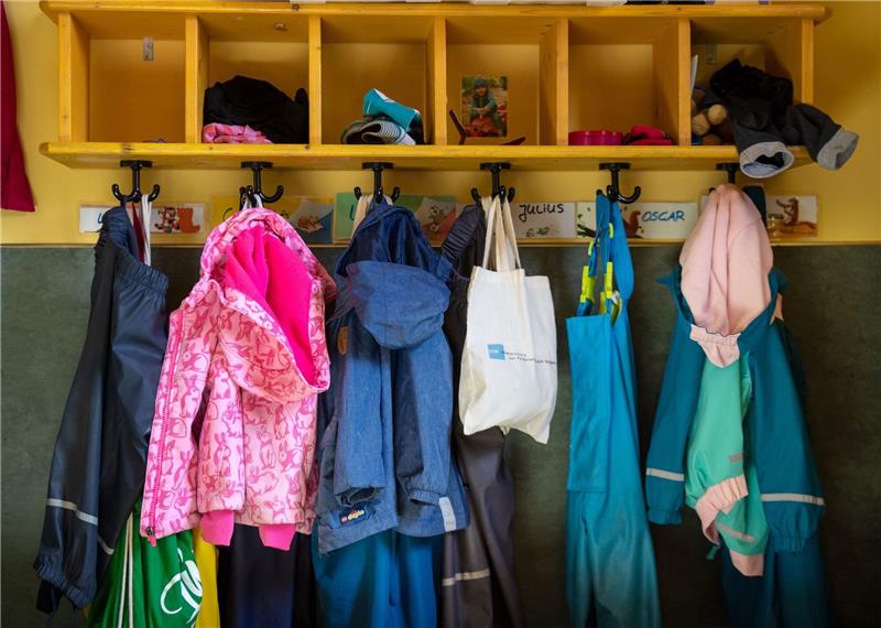 Deutlich mehr pädagogisches Personal in Kindergärten Jacken im Eingangsbereich eines Kindergartens