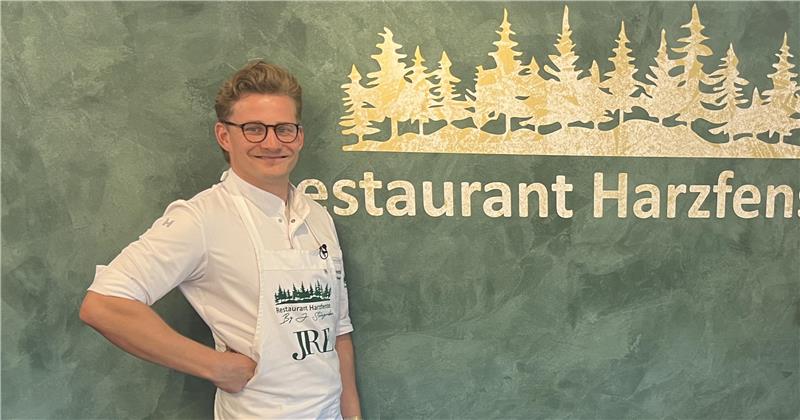 Das Bild zeigt Johannes Steingrüber vor einem Waldmotiv im Restaurant "Harzfenster" in Seesen.