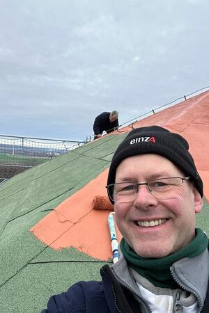 Malermeister Mathias Ujma streicht zusammen mit dem Vereinsvorsitzenden Lutz Schröder die 80 Quadratmeter Dachfläche mit Langflorrollen wieder rot.