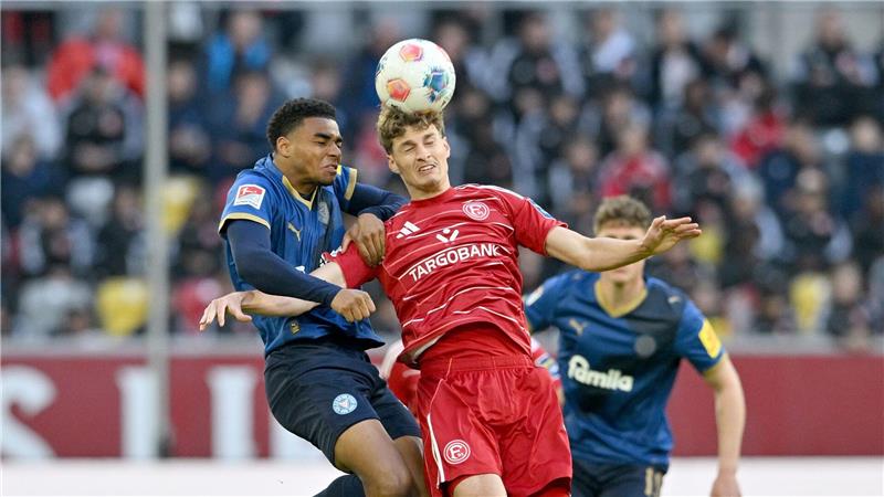 Kiels Ikem Ugoh (l) und Düsseldorfs Luca Raimund kämpfen um den Ball.