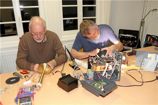 Konzentriertes Arbeiten erfordert die Reparatur einer Lampe und eines CD-Wechslers. Tilo Odernheimer und Holger Schütte (v. li.) nehmen sich Zeit und versuchen lieb gewonnene Erinnerungsstücke vor dem Mülleimer zu bewahren. Foto: Jambrek