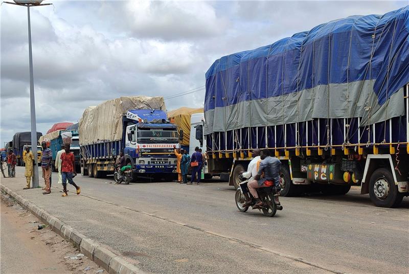 „Ein Putsch zuviel”: Westafrika berät über Militäreinsatz Lastwagen stehen an der Grenze zwischen Nigeria und Niger.