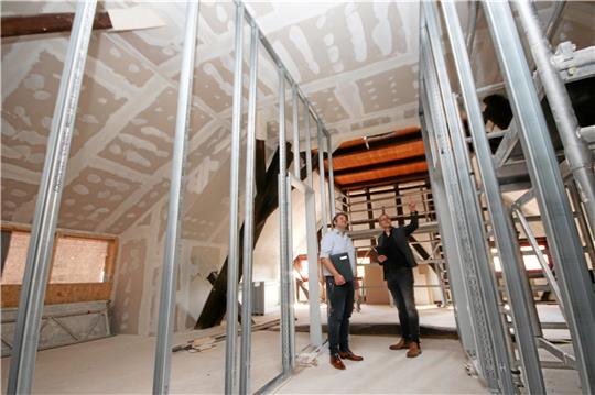 Martin Schulze, Allgemeiner Vertreter des Bürgermeisters, und Architekt Armin Meyer-Herbig machen sich im Dachgeschoss des Hauses C ein Bild vom Fortschritt der Bauarbeiten. Foto: Gereke