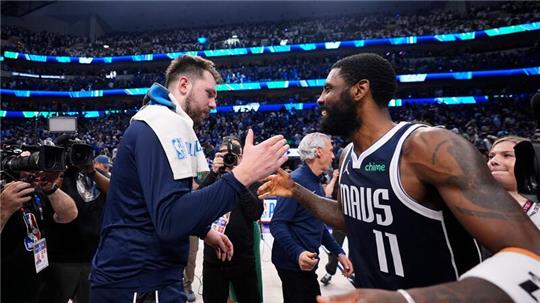 Mavericks-Guards Luka Doncic (l) und Kyrie Irving feiern den Sieg.