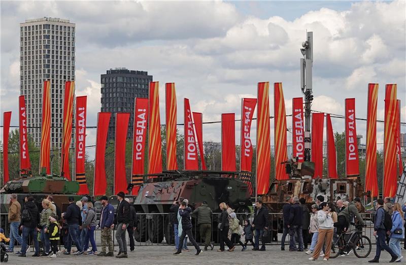 Parade ohne Sieg - Putin rüstet sich für langen Krieg Menschen besichtigen eine Schau zu Kriegstrophäen im Park Pobedy (Park des Sieges) in Moskau. Gezeigt wird Militärtechnik aus verschiedenen westlichen Ländern und der Ukraine. Im Hintergrund zu sehen sind rote Fahnen mit der Aufschrift Pobeda! (auf Deutsch: Sieg).