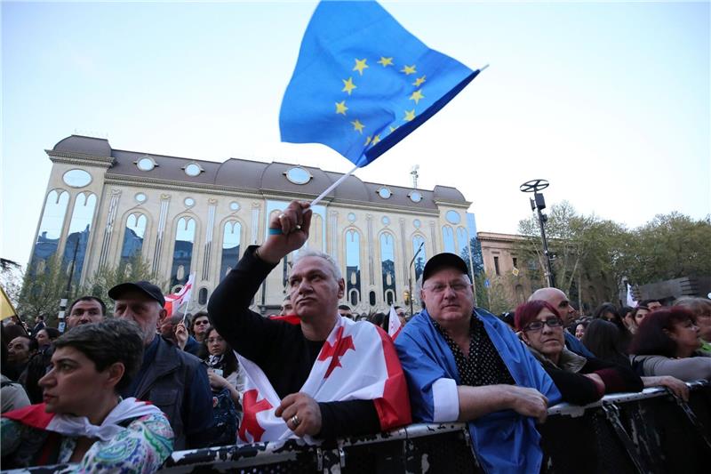 Georgiens Parlament treibt umstrittenes Gesetz voran Mit EU- und Georgien-Flagge: Menschen protestieren in Tiflis gegen das umstrittene Gesetz.