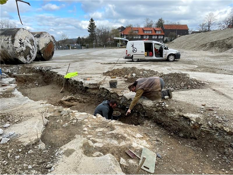 Archäologen suchen nach historischen Mauerresten Mit Hand und Kelle untersuchen Fachleute den freigelegten Streifen unter dem Asphalt – hier der Archäologe Robert Brosch (r.) und sein Kollege Javier Muñoz. Foto: Kleine