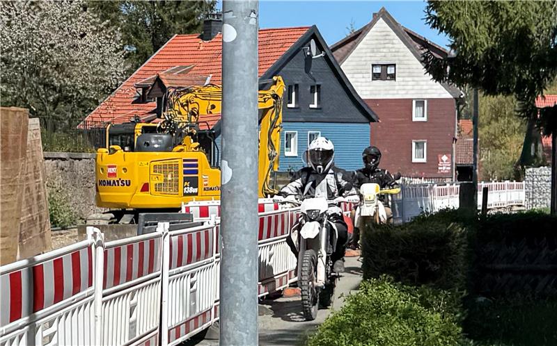 Das Foto zeigt zwei Motorradfahrer, die auf dem Gehweg fahren.