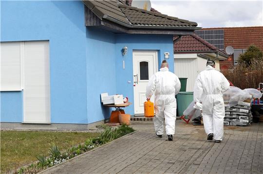 Mitarbeiter der Kriminaltechnik gehen in das  Haus in Rövershagen, in dem drei Menschen getötet worden sein sollen.