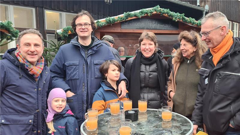 Großer Besucheransturm auf Goslars Weihnachtsmarkt unter Tage Mehrere Menschen stehen an einem Stehtisch. Auf dem Tisch stehen Tassen mit hellem Apfelpunsch.