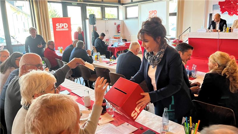 Goslar: Sozialdemokraten nominieren Amtsinhaber Dr. Alexander Saipa Eine Frau geht mit einem Karton durch die Reihen eines Saals, in den Wahlzettel gesteckt werden.
