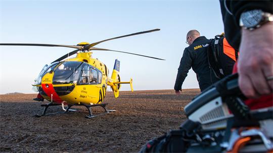 Nach einem Einsatz geht die Besatzung vom Rettungshelikopter Christoph 30 der ADAC Luftrettung zurück zum Hubschrauber. 