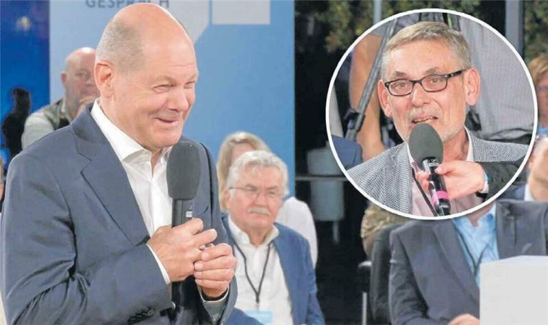 Scholz schmunzelt: Kurzes Video reicht für Pseudo-Skandal Nach knapp 16 von 90 Minuten des Mitschnitts auf der Website des Presse- und Informationsamtes der Bundesregierung gibt es die Szene, da sich Scholz im Gespräch mit Hendrik Wolf-Doettinchem (kleines Bild) überraschend gut gelaunt gibt. Foto: Bundesregierung/ Collage: Jürgen Runo