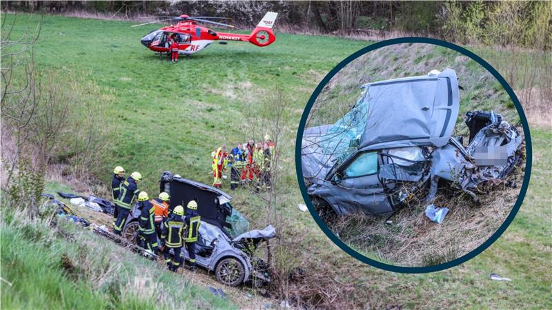 Der Kia steht nach dem Unfall an der 30 Meter tiefen Böschung. Ein Rettungshubschrauber im Hintergrund.