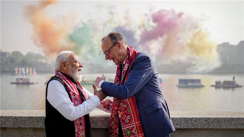 Narendra Modi, Premierminister von Indien, und Bundeskanzler Friedrich Merz (r, CDU) stehen am Rande eines Drachenfestivals vor einem Feuerwerk am Ufer des Sabarmati in Ahmedabad.