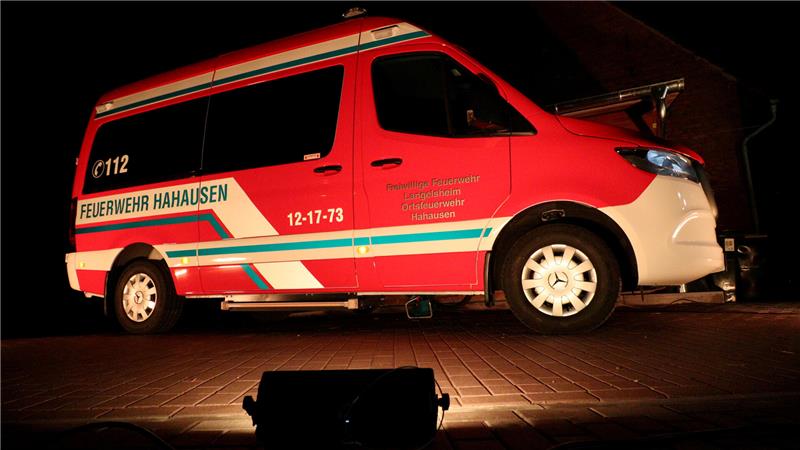 Ein Scheinwerfer strahlt ein Feuerwehrfahrzeug an.