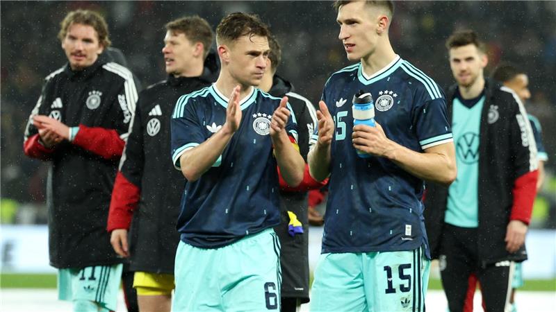 Nico Schlotterbeck (r.) spricht auf dem Platz mit DFB-Kapitän Joshua Kimmich. 