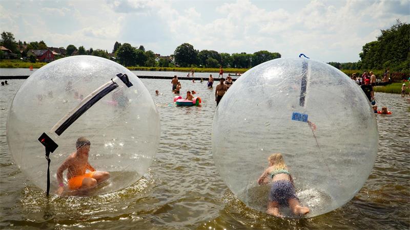 Beste Wetteraussichten für das See- und Sommerfest im Oberharz Kinder in Wasserbällen auf dem Teich.