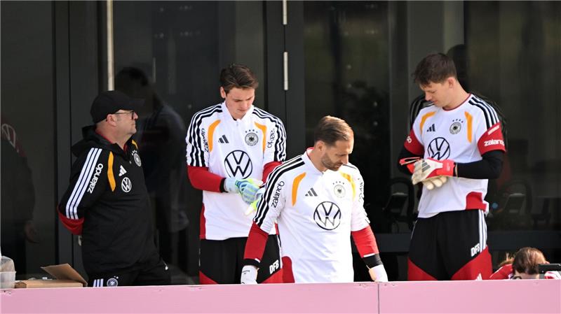 Oliver Baumann (M) bereitet sich mit Jonas Urbig (2.v.l) und Alexander Nübel (r) auf das Training vor. 