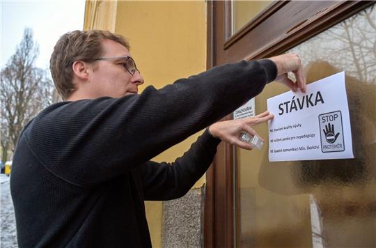 Ondrej Levak, ein Vertreter der Schulgewerkschaft, befestigt ein Informationsblatt am Eingang des Gymnasium Jihlava.