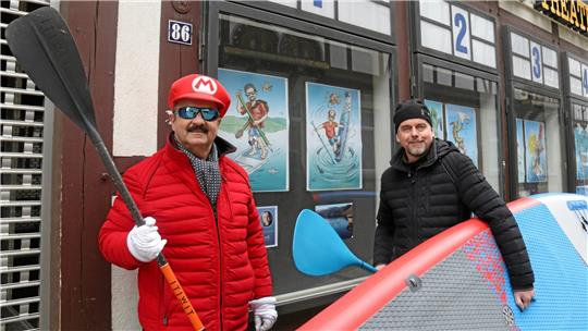 Original und Cartoon-Fassung: Künstler Thomas Velte (rechts) porträtierte Wassersportler wie Günter „Super Mario“ Koschig und sich selbst. Foto: Hartmann