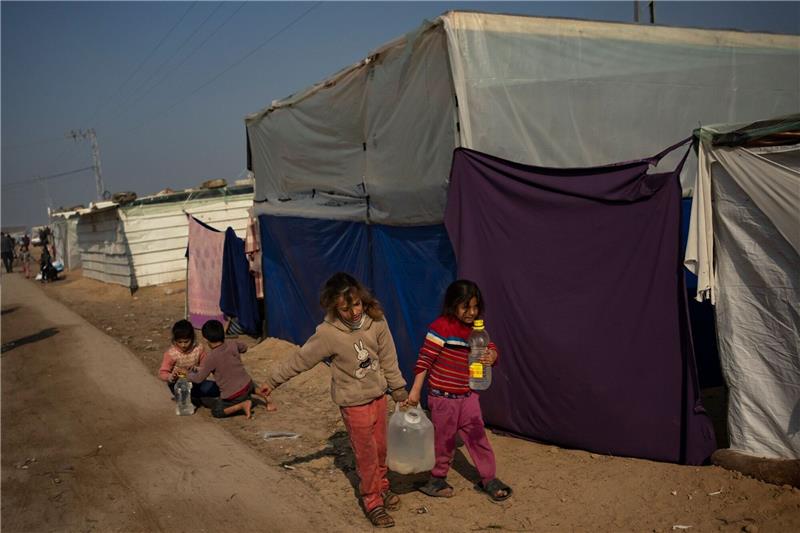 Neue Wasserleitung versorgt Gazastreifen aus Ägypten Palästinensische Kinder tragen Wasser in einem behelfsmäßigen Zeltlager.