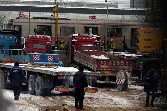 Polizisten in der Nähe des Ortes, wo sich der Zug-Unfall in Peking ereignete. Bei starkem Schneefall sind in Peking zwei U-Bahn-Züge zusammengestoßen.