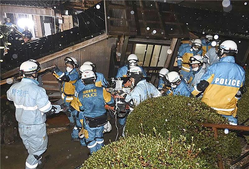 Nach Beben in Japan: Über 90 Jahre alte Frau gerettet Polizisten retten im japanischen Suzu eine Frau aus einem eingestürzten Haus.