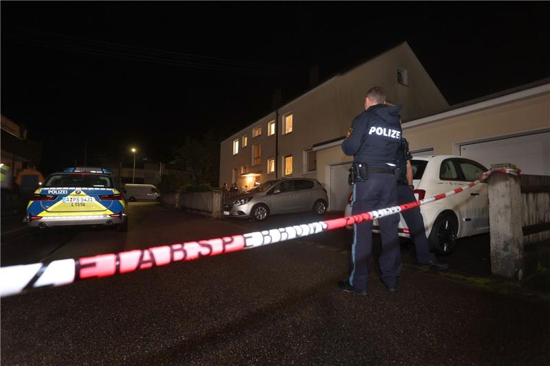 Mann erschießt drei Menschen in Mehrfamilienhaus in Schwaben Polizisten stehen vor einem Haus, in dem drei Menschen erschossen wurden.
