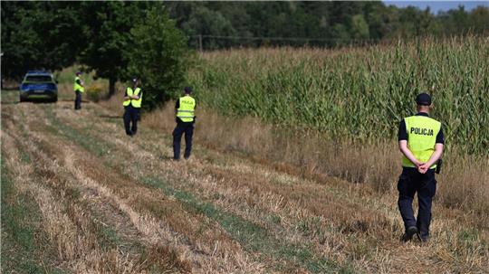 Polnische Polizisten sichern das Gebiet eines Maisfeldes in Osiny in Ostpolen, in das ein unbekanntes Flugobjekt gestürzt ist. (Foto aktuell)