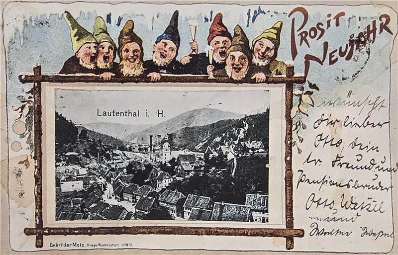 Historische Glückwunsch-Motive aus Goslar und Umgebung Postkarte mit einer Schwarz-weiß-Ansicht von Lautenthal im Harz, umrahmt von einer Gruppe von sechs Zwergenfiguren mit spitzen Hüten und der handschriftlichen Aufschrift 'Prosit Neujahr'